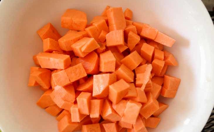 Meanwhile, first peel and then dice the sweet potatoes into very small chunks (1/5-inch cubes). Place sweet potato cubes into saucepan and replace the lid. 