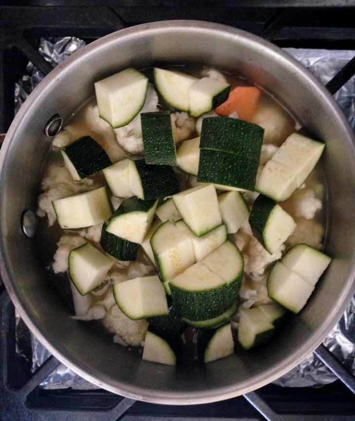 Dice the zucchini and place into sauce pan. Add the curry powder and salt to taste and replace the lid. 