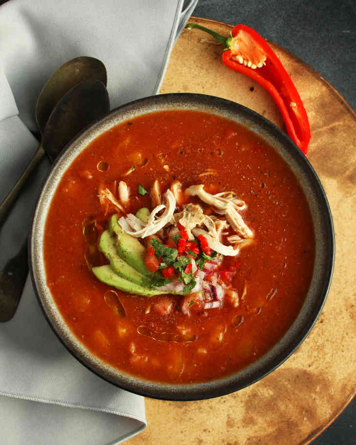 Spicy Paleo Chicken Enchilada Soup Recipe #paleo https://paleoflourish.com/spicy-paleo-chicken-enchilada-soup-recipe